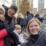 The Singing Suitcase owner Melissa with her husband Bill and two daughters on vacation at the Rockefeller Center Christmas tree