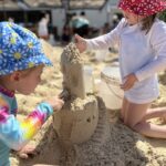 The Singing Suitcase owner Melissa's daughters building a sand castle