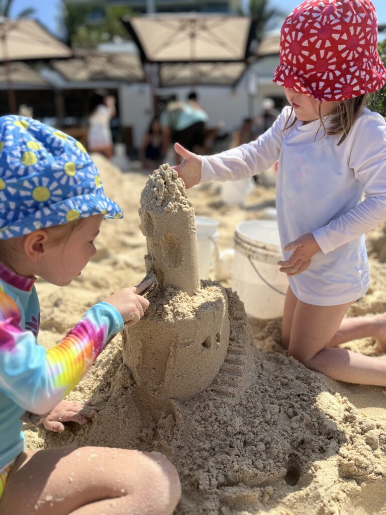 The Singing Suitcase owner Melissa's daughters building a sand castle